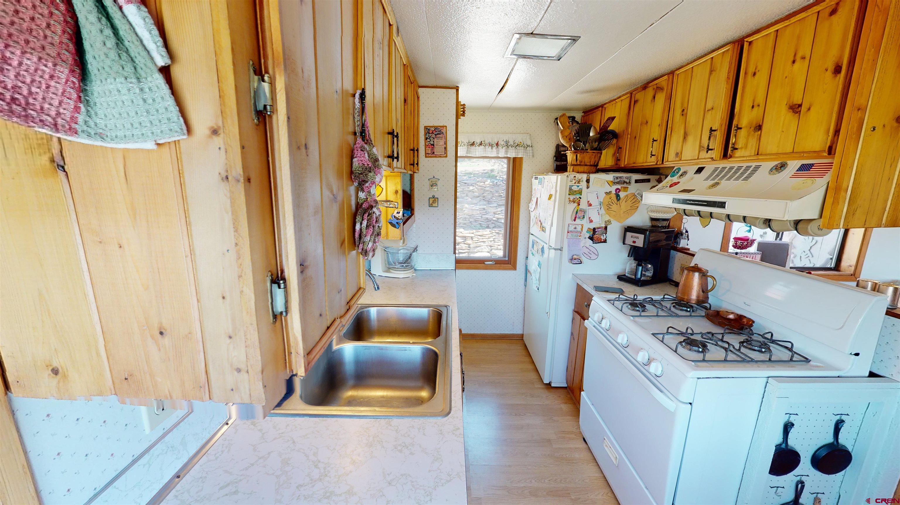 337 County Road 4018 Navajo Dam, CO 87419 - Photo 14 of 20 a kitchen with stainless steel appliances a refrigerator and a stove