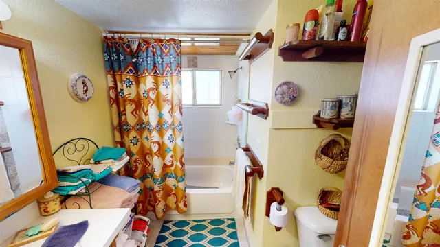 a bedroom with furniture and a window