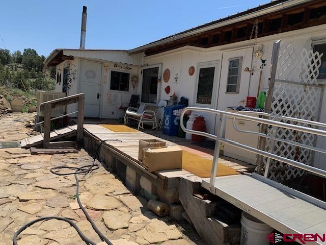 337 County Road 4018 Navajo Dam, CO 87419 - Photo 3 of 20 a view of a balcony with two chairs and a potted plant