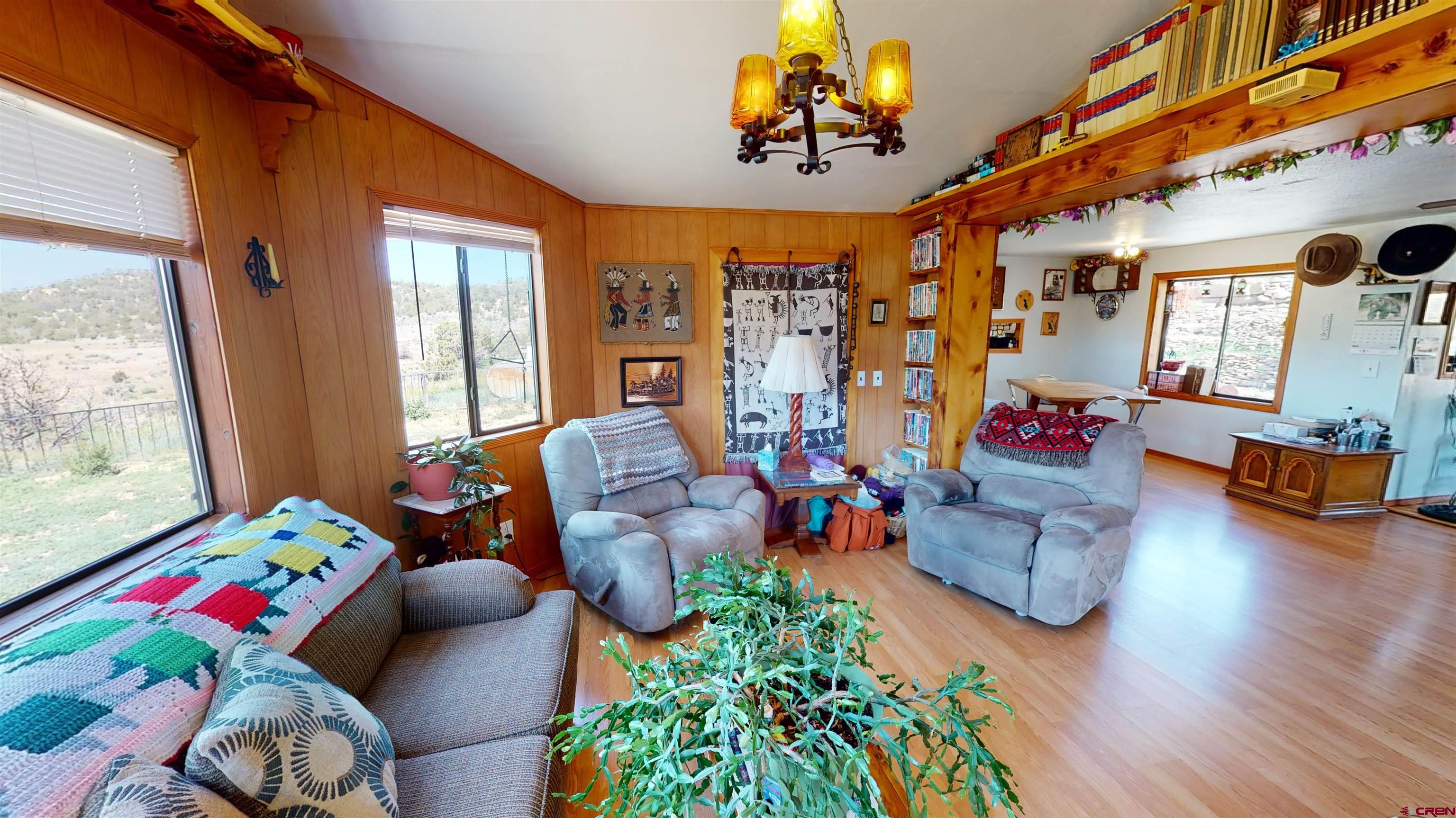 337 County Road 4018 Navajo Dam, CO 87419 - Photo 8 of 20 a living room filled with furniture and a floor to ceiling window