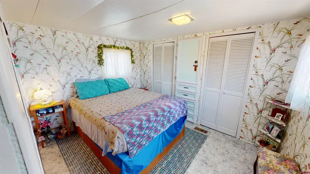 a bed room with a bed and a chair