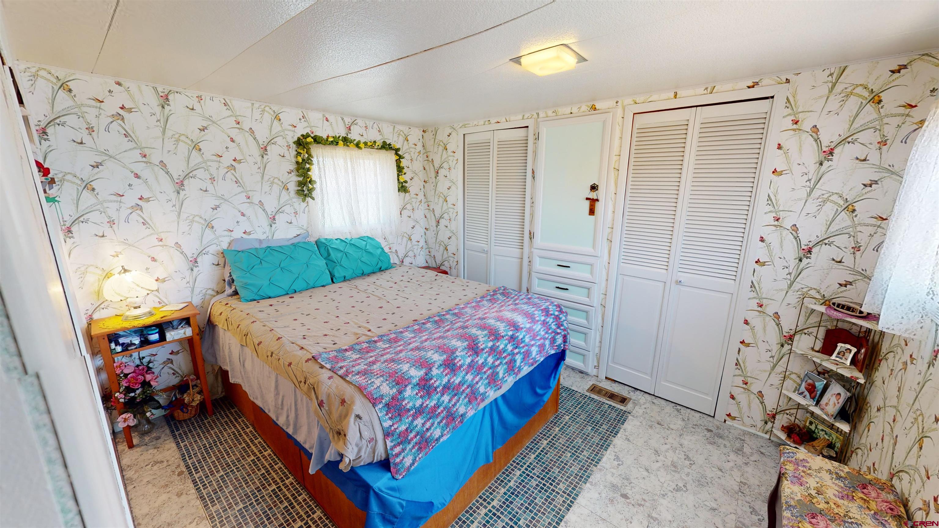 337 County Road 4018 Navajo Dam, CO 87419 - Photo 10 of 20 a bedroom with a bed and a walk in closet