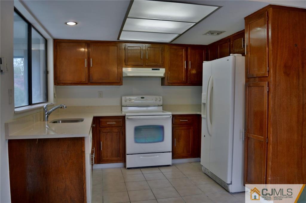 40 A Haddon Road Monroe Township, NJ 08831 - Photo 4 of 11 a kitchen with stainless steel appliances granite countertop a refrigerator and a sink