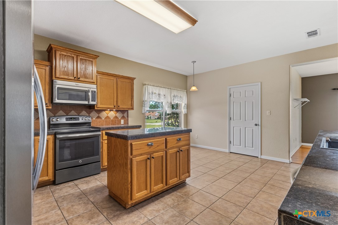 283 County Road 4710 Kempner, TX 76539 - Photo 18 of 47 a kitchen with stainless steel appliances granite countertop a refrigerator and a stove top oven