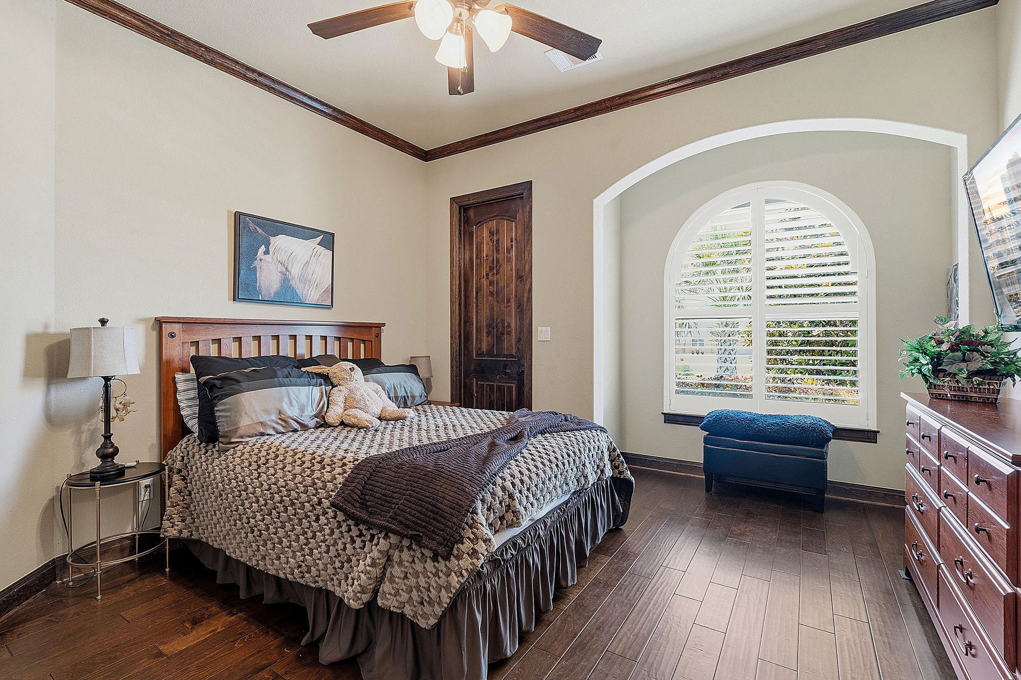 816 Brave Face Street Leander, TX 78641 - Photo 23 of 40 Rich hardwood floors complement dark crown molding in this naturally illuminated bedroom.