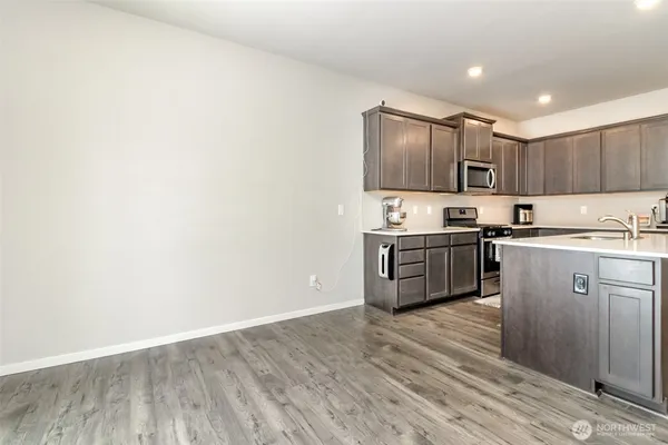 a kitchen with granite countertop a sink and cabinets