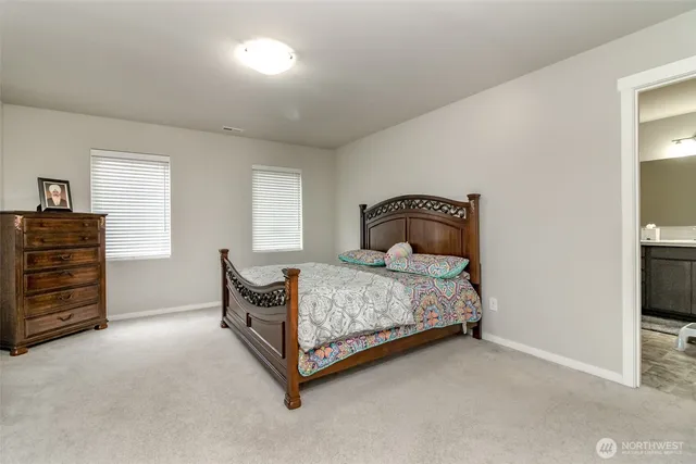 a bedroom with a bed and a tv