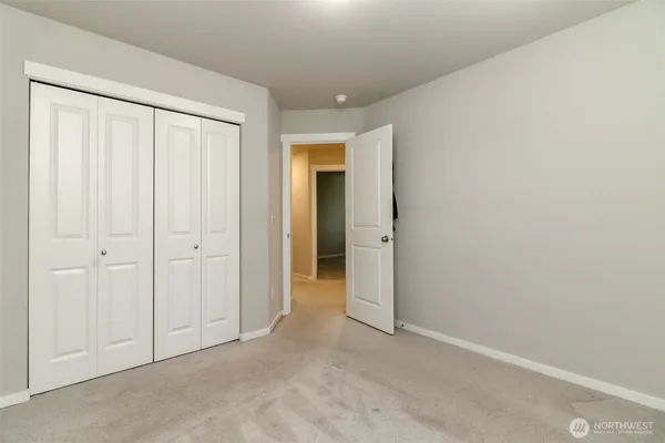 a view of an empty room and closet area