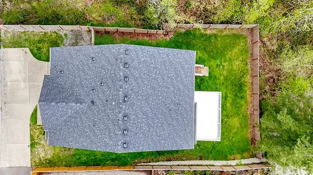 an aerial view of a house with a yard
