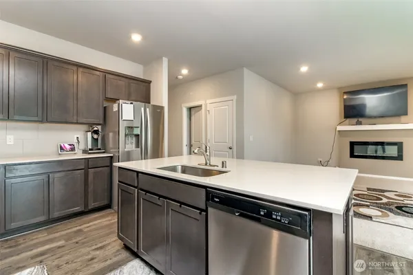 a kitchen with a sink and a stove top oven