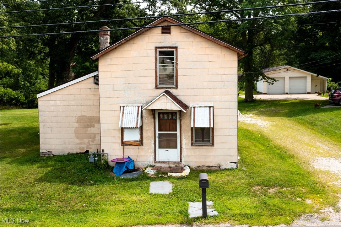 6283 Lafayette Road Medina, OH 44256 - Photo 1 of 8 View of front of house with a front lawn, a detached garage, and an outbuilding