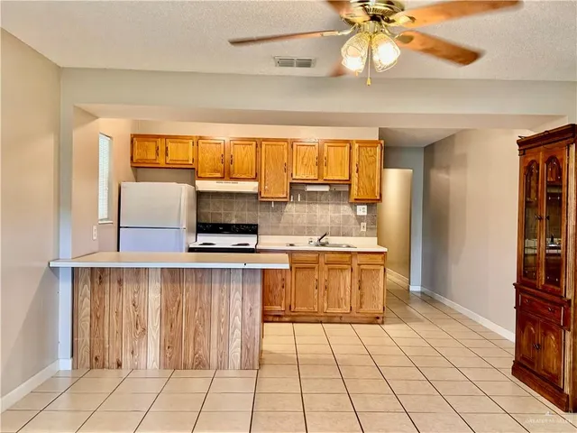 a kitchen with a sink cabinets and window