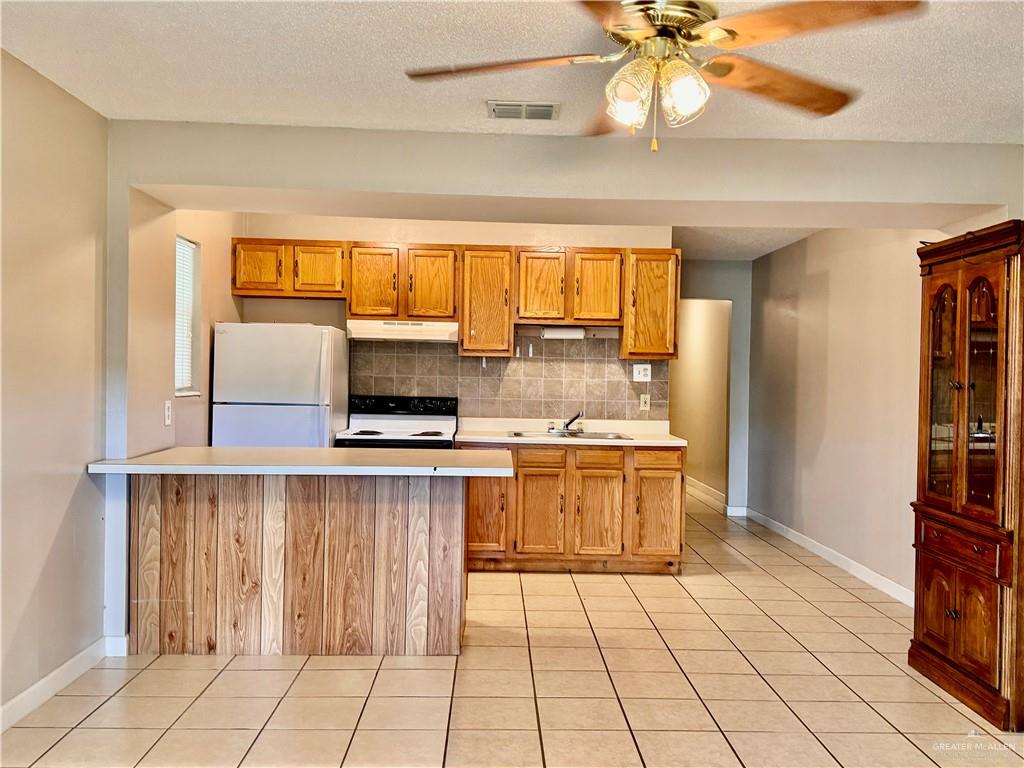 3415 North Kenyon Road, Unit 3 Edinburg, TX 78542 - Photo 6 of 15 a kitchen with a sink cabinets and window