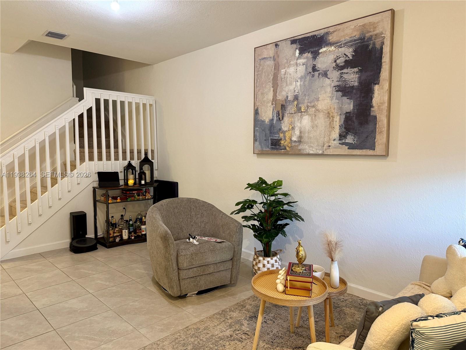 23049 Southwest 129th Place Miami, FL 33177 - Photo 4 of 29 a living room with furniture and a painting