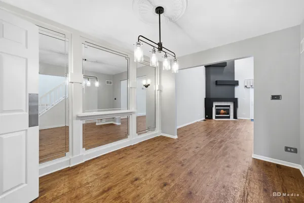 a view of an empty room with a kitchen and a window