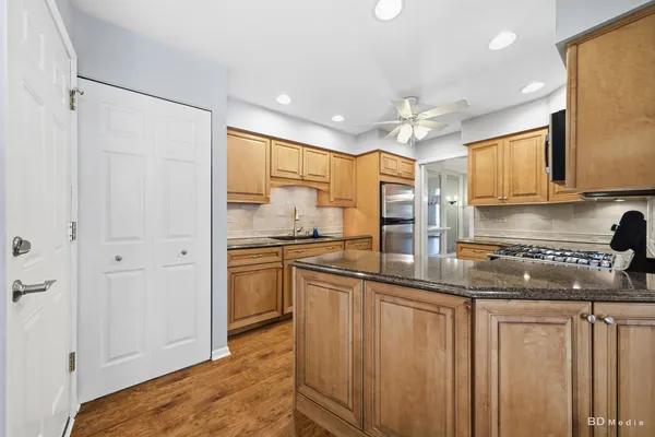 a kitchen with stainless steel appliances granite countertop a sink and cabinets