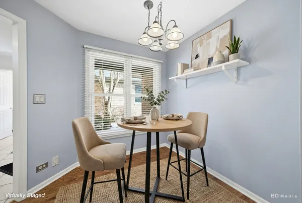 a view of a dining room with furniture wooden floor and a chandelier