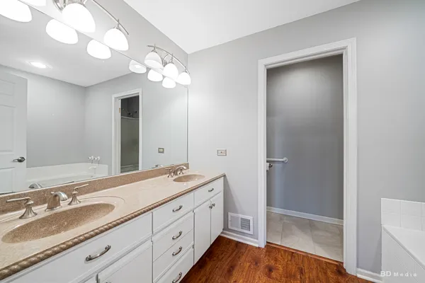 a bathroom with a double vanity sink and a mirror