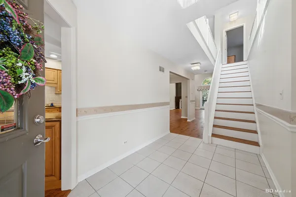a view of entryway and hall with wooden floor
