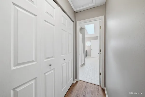 a view of a hallway with wooden floor