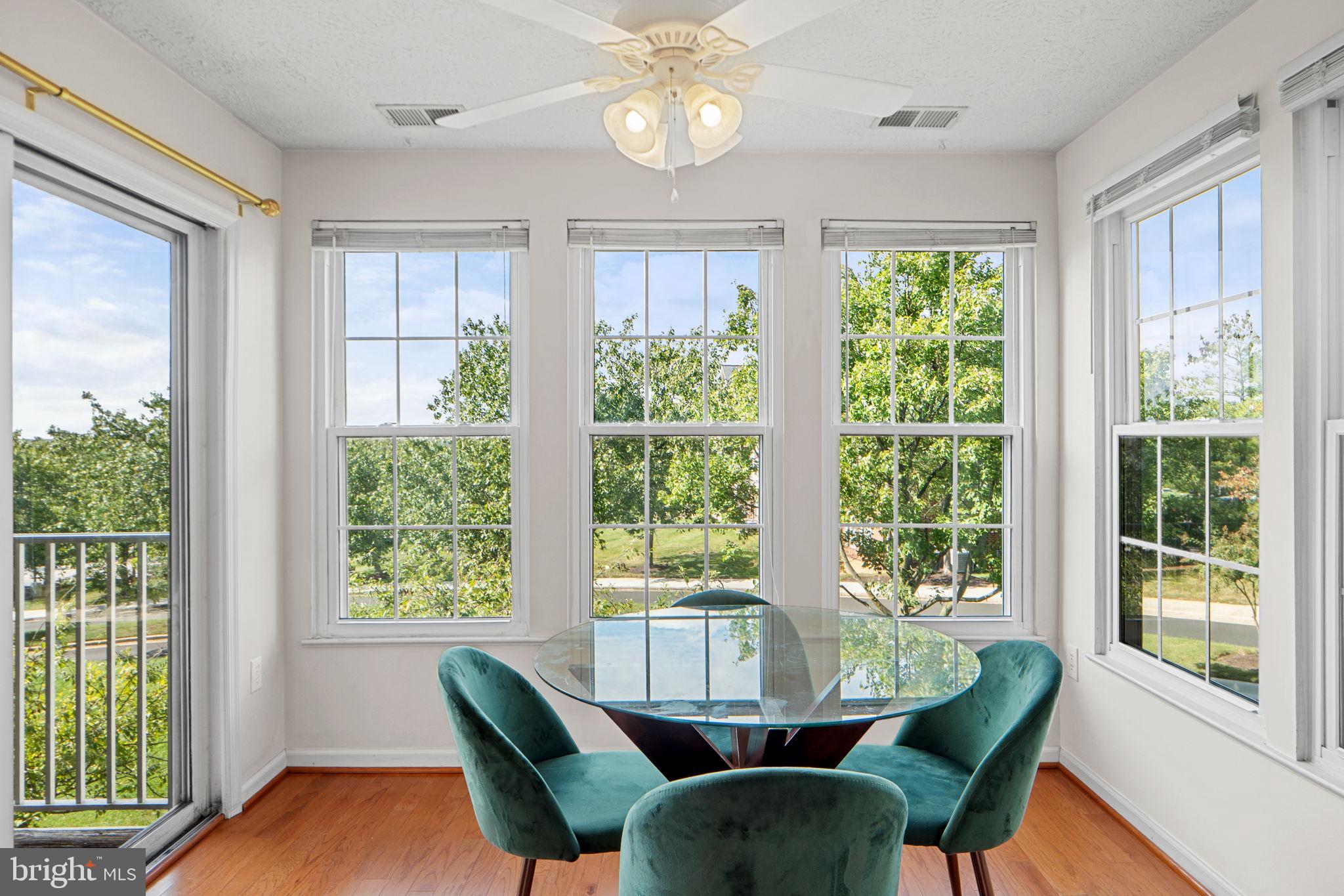 699 Winding Stream Way, Unit 203 Odenton, MD 21113 - Photo 15 of 41 a view of a dining room with furniture a chandelier and wooden floor