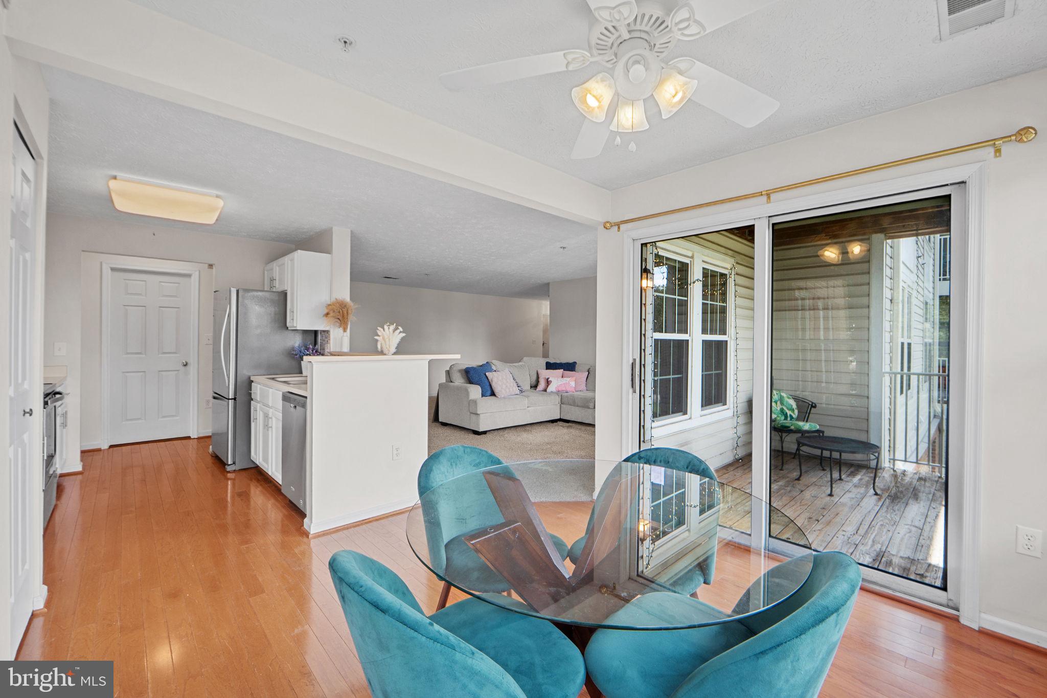 699 Winding Stream Way, Unit 203 Odenton, MD 21113 - Photo 16 of 41 a living room with furniture a chandelier and kitchen view