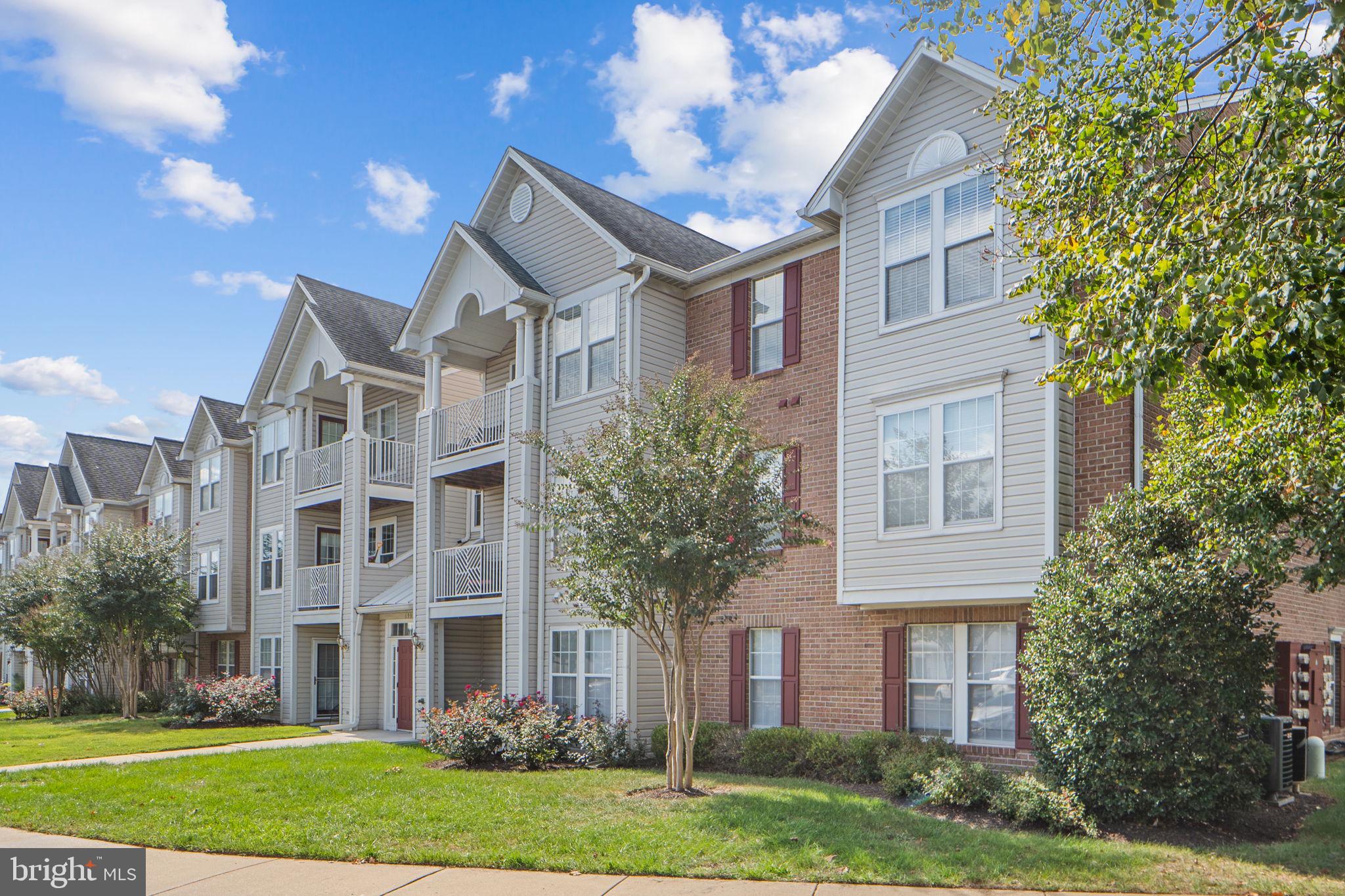 699 Winding Stream Way, Unit 203 Odenton, MD 21113 - Photo 26 of 41 a front view of a house with a yard