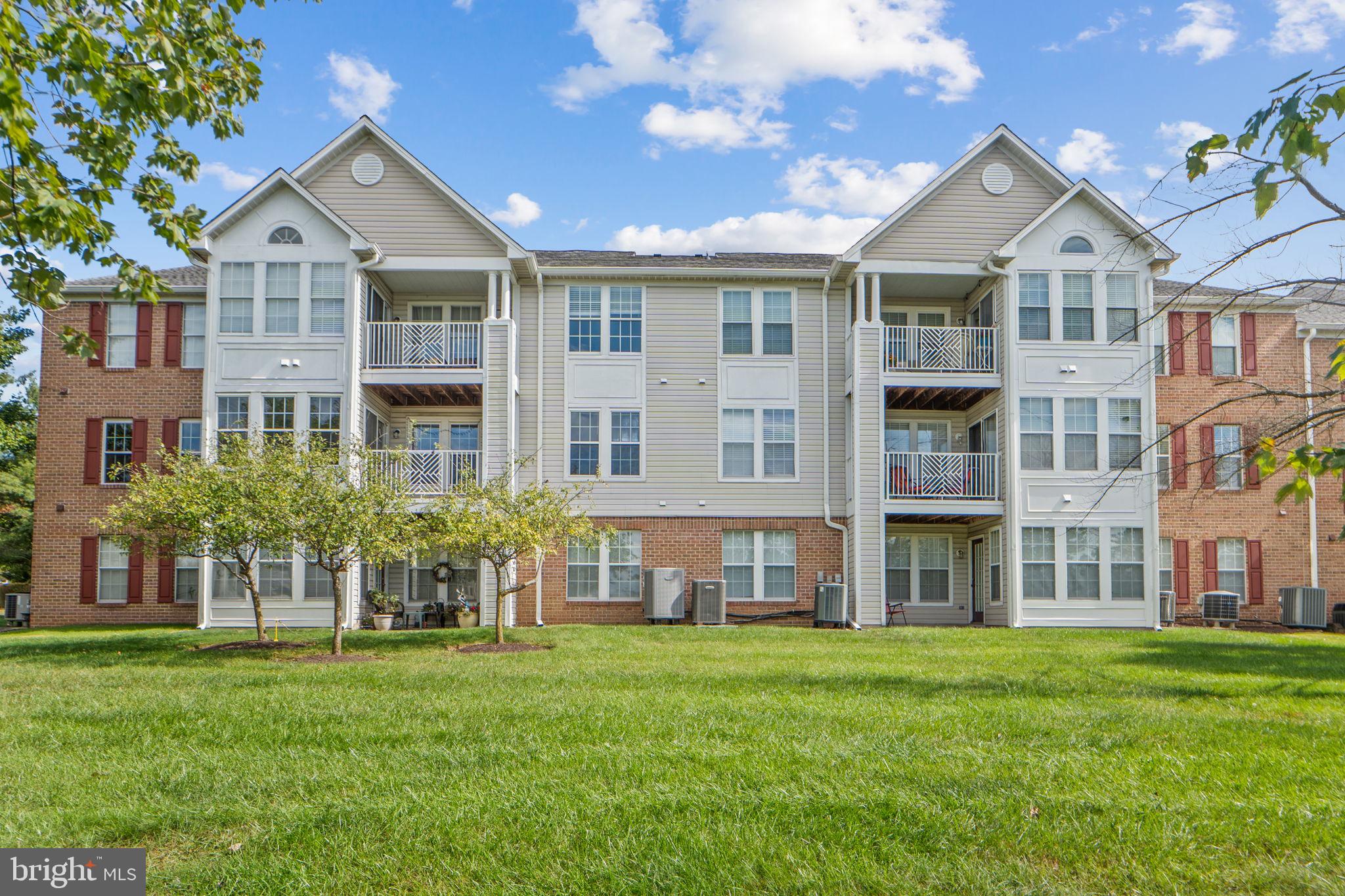 699 Winding Stream Way, Unit 203 Odenton, MD 21113 - Photo 27 of 41 a front view of a house with a yard