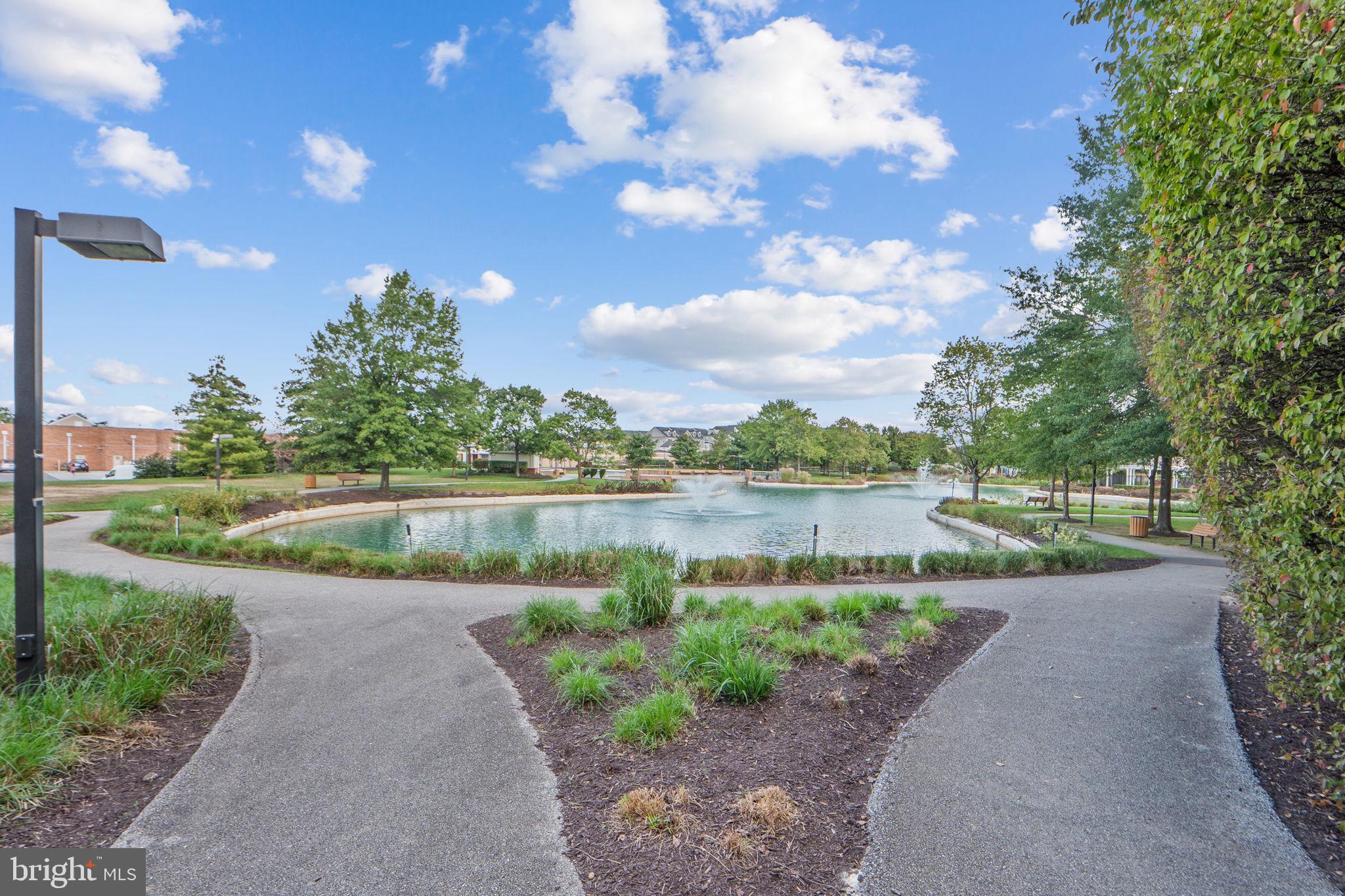 699 Winding Stream Way, Unit 203 Odenton, MD 21113 - Photo 39 of 41 a view of a lake with a big yard and potted plants