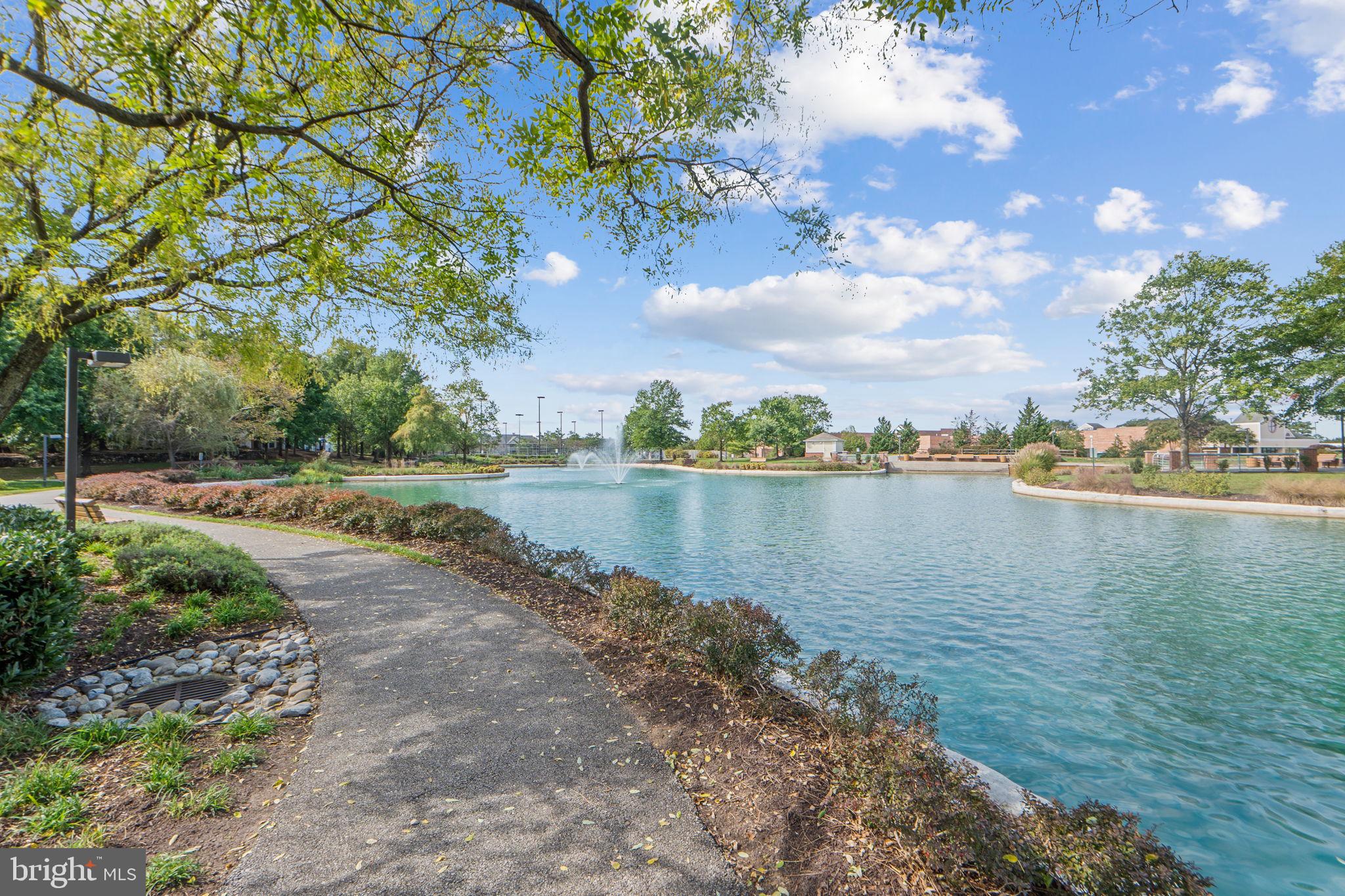 699 Winding Stream Way, Unit 203 Odenton, MD 21113 - Photo 40 of 41 a view of a lake with houses in the back