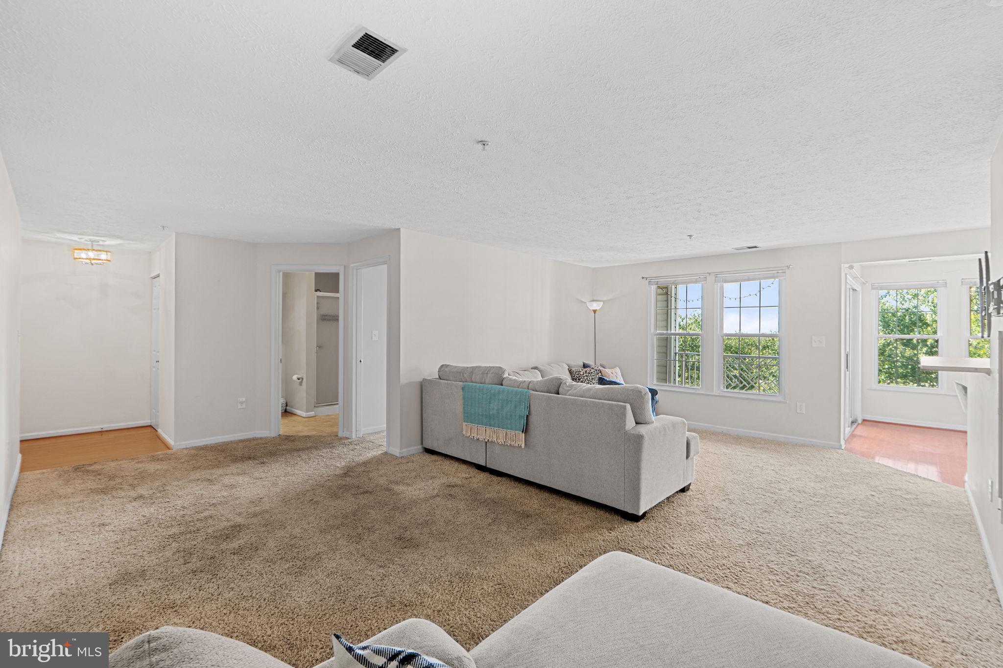 699 Winding Stream Way, Unit 203 Odenton, MD 21113 - Photo 7 of 41 a living room with furniture and a large window