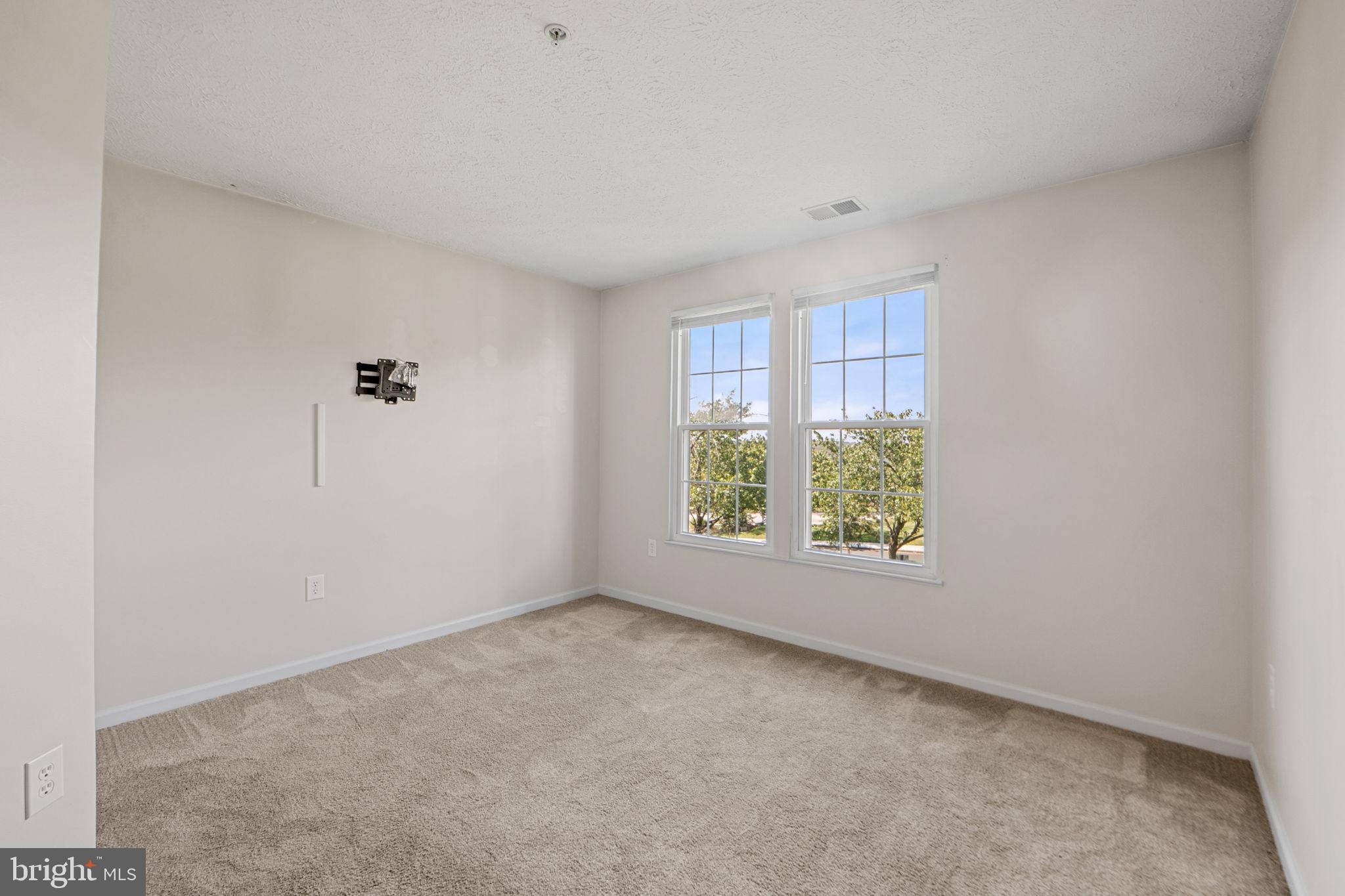 699 Winding Stream Way, Unit 203 Odenton, MD 21113 - Photo 8 of 41 an empty room with windows