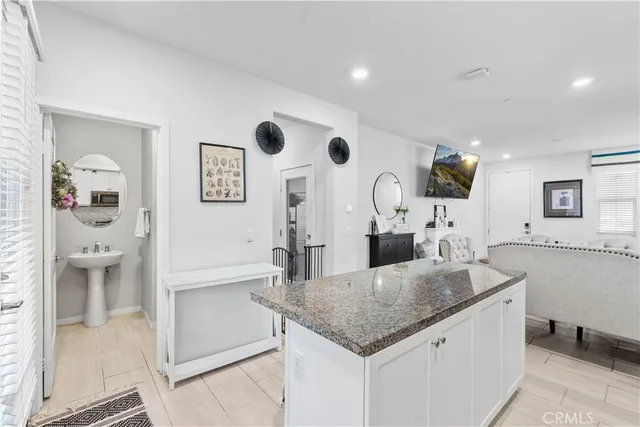 a kitchen with stainless steel appliances granite countertop a sink and a refrigerator