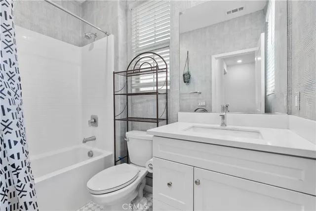 a bathroom with a sink toilet a mirror and shower