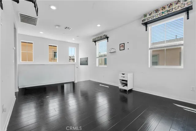 a room with wooden floor and a window