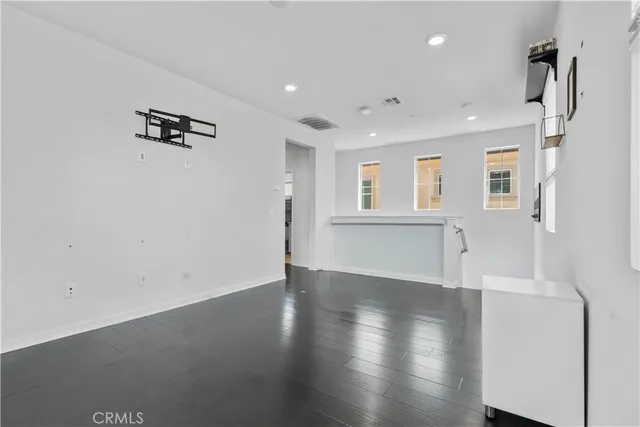 an empty space with wooden floor and a window