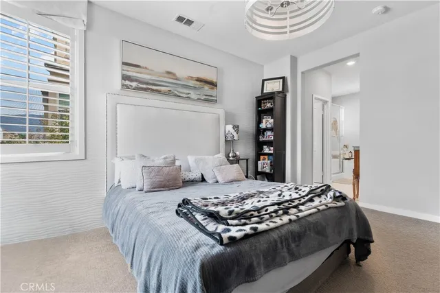 a bedroom with a large bed and a window