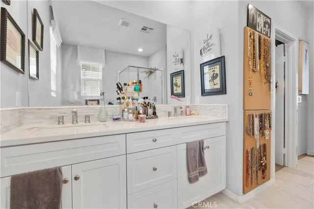 a bathroom with cabinets sink and mirror