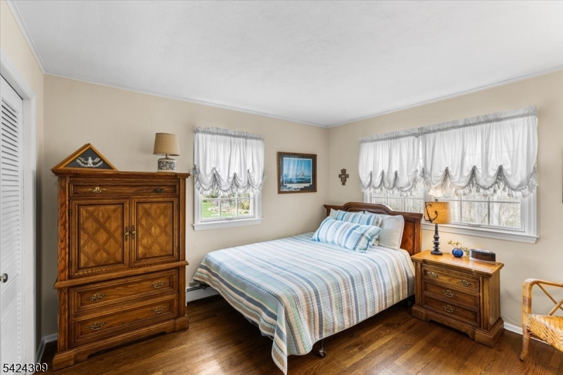 58 Andover Road Sparta, NJ 07871 - Photo 22 of 38 a bedroom with a bed and wooden floor