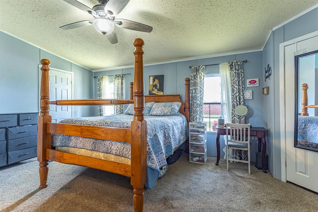 75 Southern Road Mineral Wells, TX 76067 - Photo 14 of 31 a bedroom with a bed and a chandelier