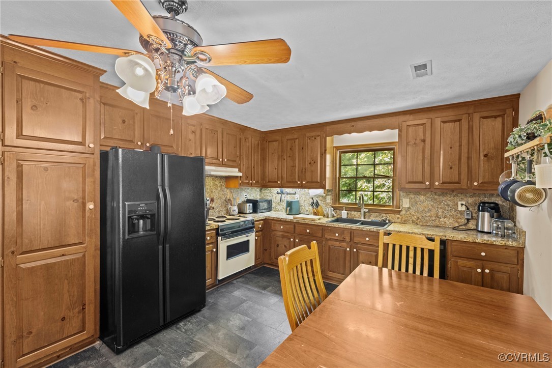 6137 Dijon Drive Mechanicsville, VA 23111 - Photo 11 of 44 a kitchen with stainless steel appliances granite countertop a refrigerator a sink dishwasher a stove with wooden cabinets and floor