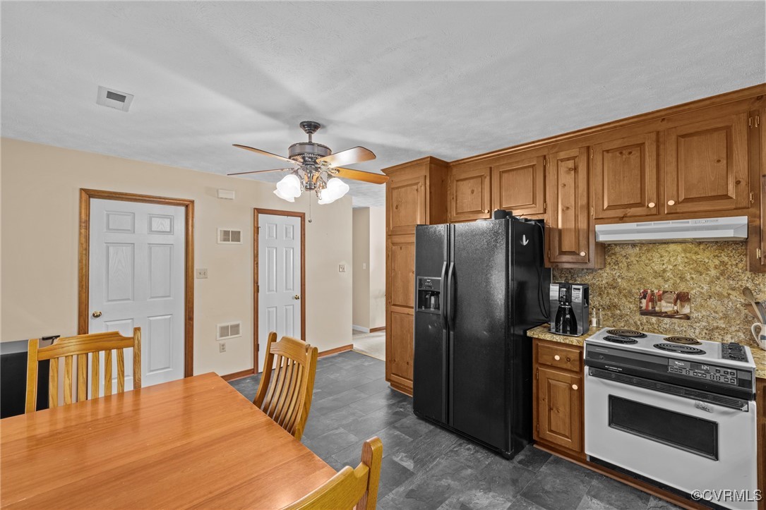 6137 Dijon Drive Mechanicsville, VA 23111 - Photo 12 of 44 a kitchen with stainless steel appliances granite countertop a refrigerator a stove a sink a dining table and chairs with wooden floor