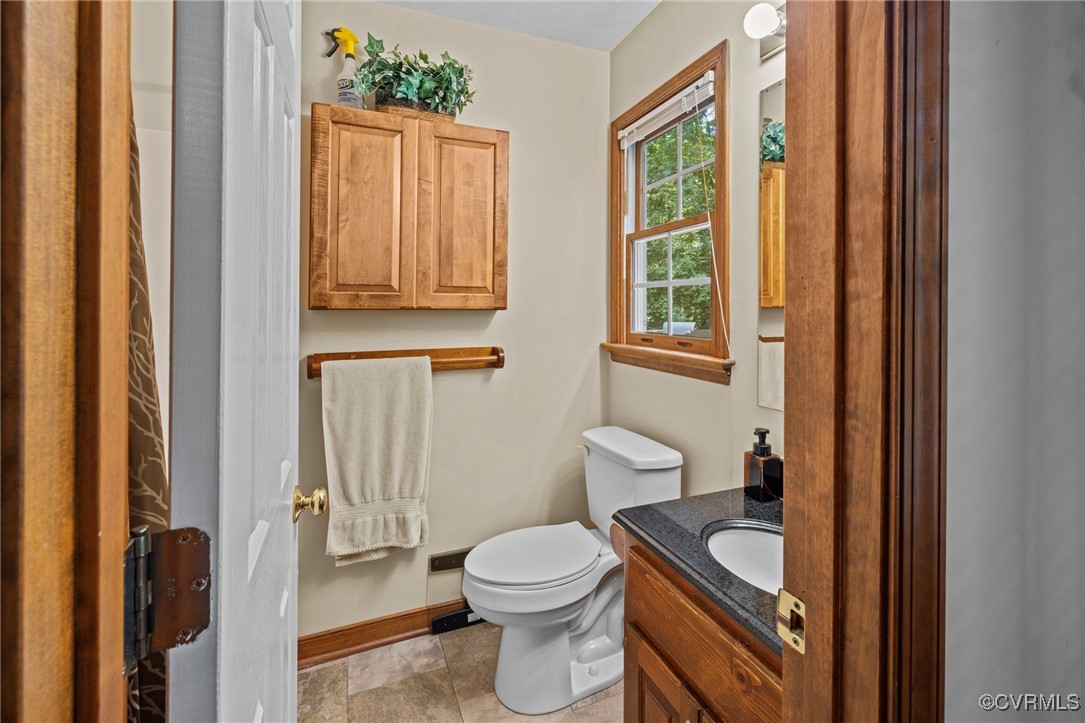 6137 Dijon Drive Mechanicsville, VA 23111 - Photo 19 of 44 a bathroom with a toilet a sink and a window