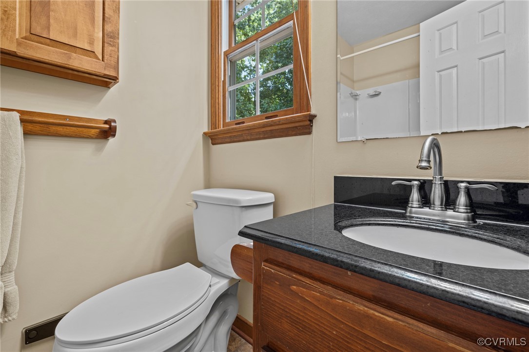 6137 Dijon Drive Mechanicsville, VA 23111 - Photo 20 of 44 a bathroom with a granite countertop toilet sink and mirror