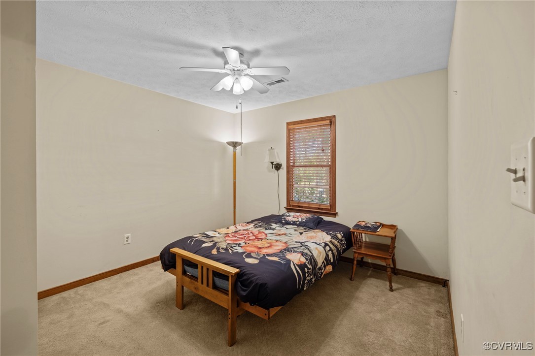 6137 Dijon Drive Mechanicsville, VA 23111 - Photo 25 of 44 a bedroom with a bed and a chandelier