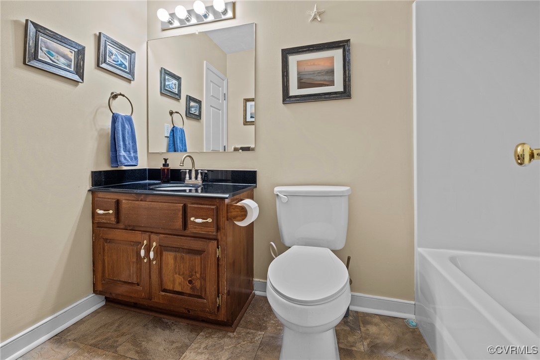 6137 Dijon Drive Mechanicsville, VA 23111 - Photo 28 of 44 a bathroom with a sink a toilet and mirror
