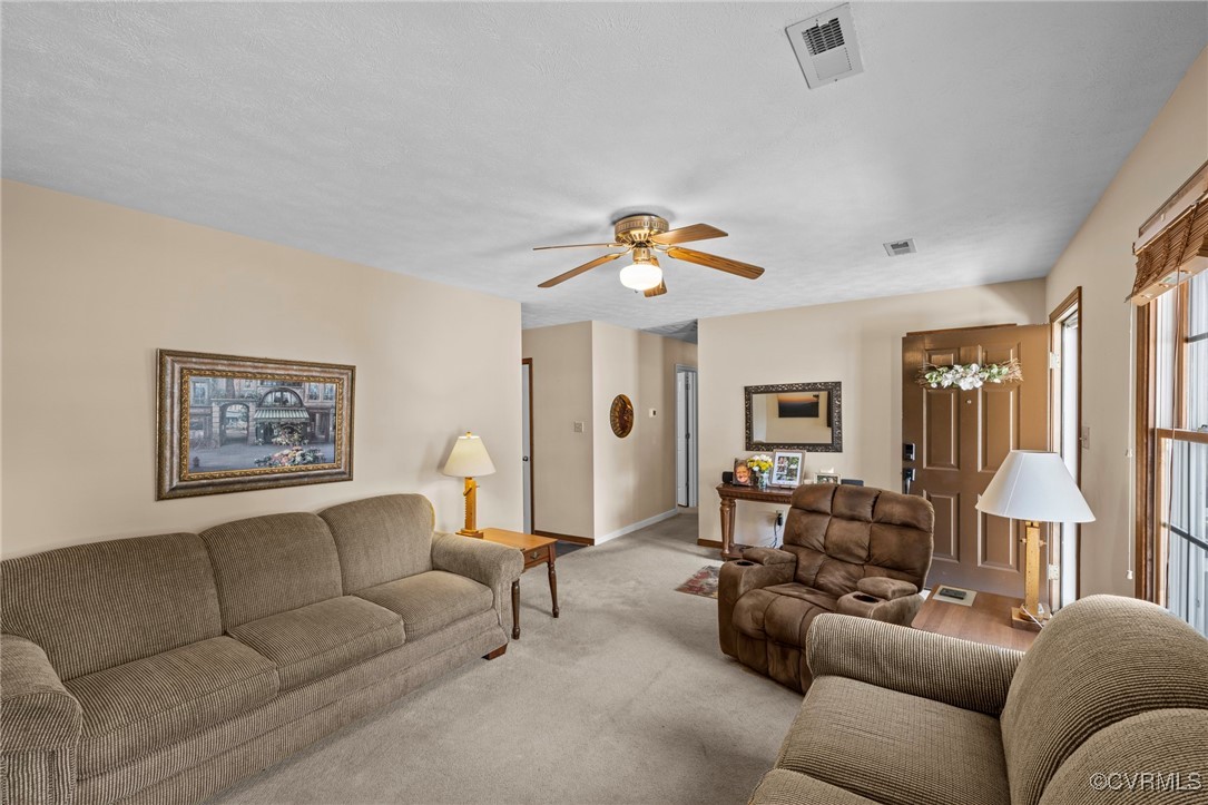 6137 Dijon Drive Mechanicsville, VA 23111 - Photo 9 of 44 a living room with furniture and a chandelier