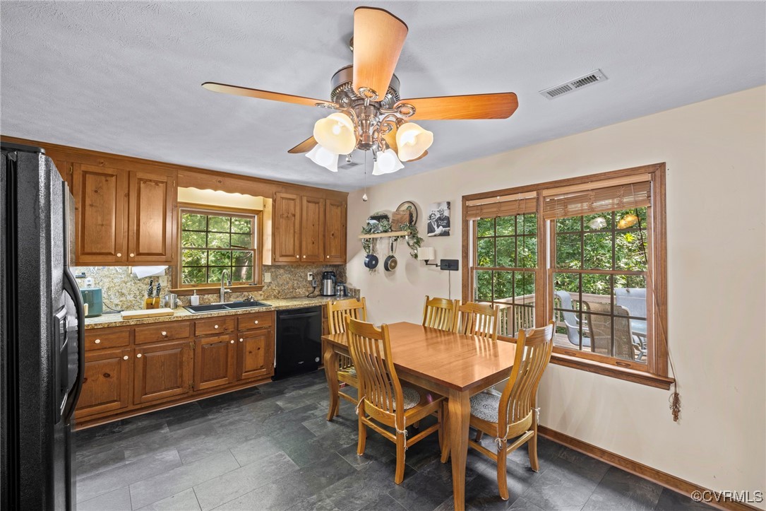 6137 Dijon Drive Mechanicsville, VA 23111 - Photo 10 of 44 a dining room with chandelier fan and wooden furniture