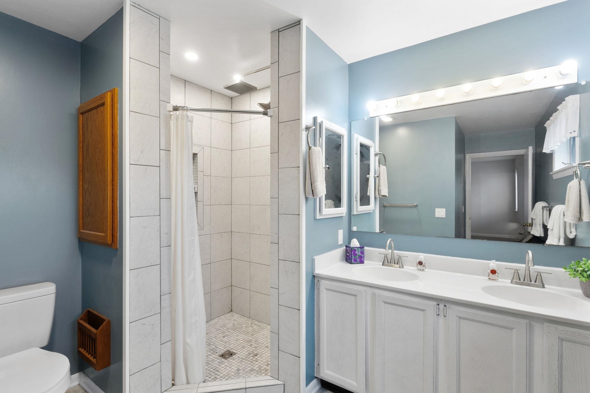 3210 Arrowhead Road Harrisonburg, VA 22801 - Photo 19 of 44 a bathroom with a shower sink and mirror