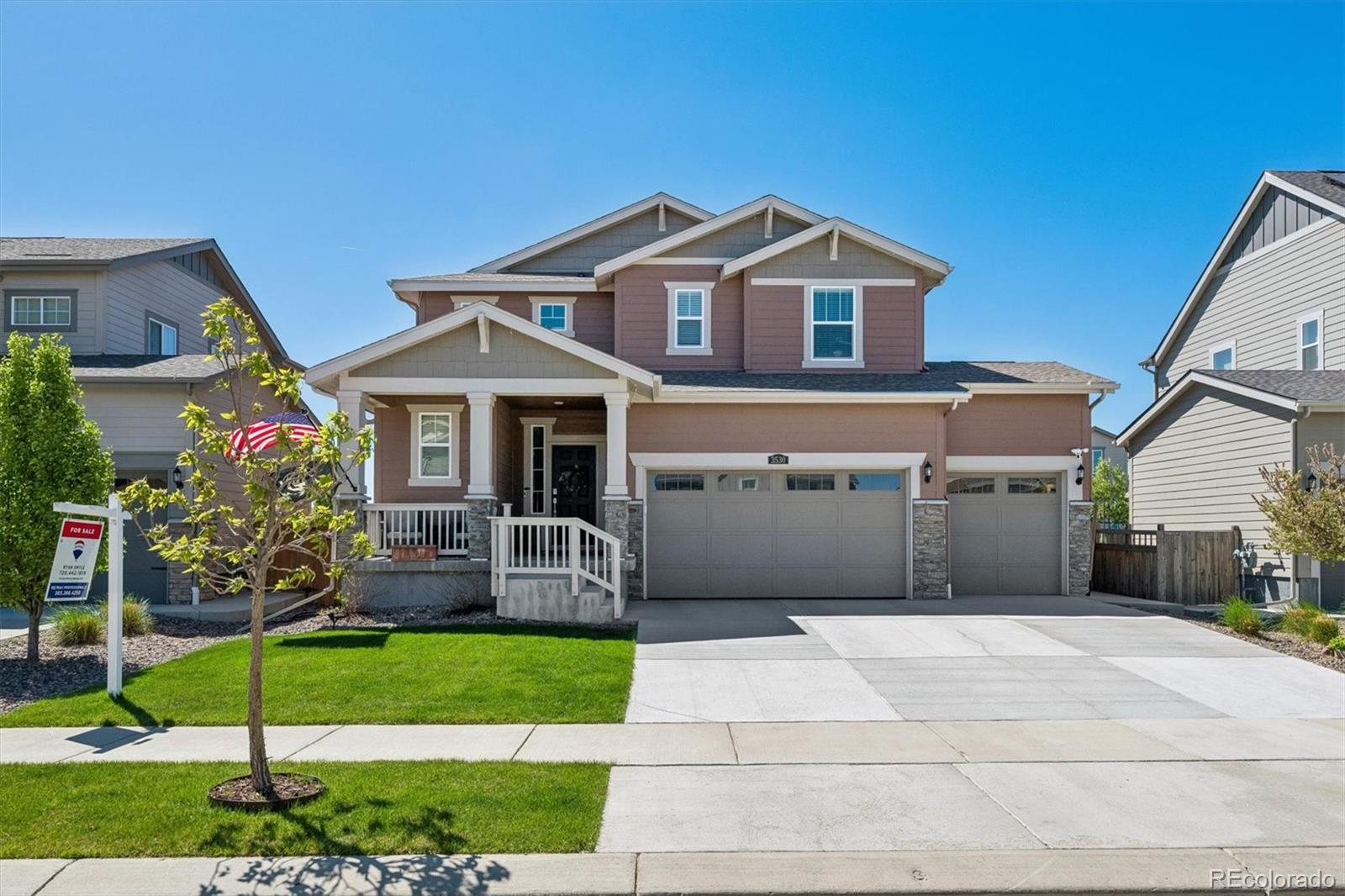 3530 Sawtooth Street Frederick, CO 80516 - Photo 1 of 36 a front view of a house with a garden and plants